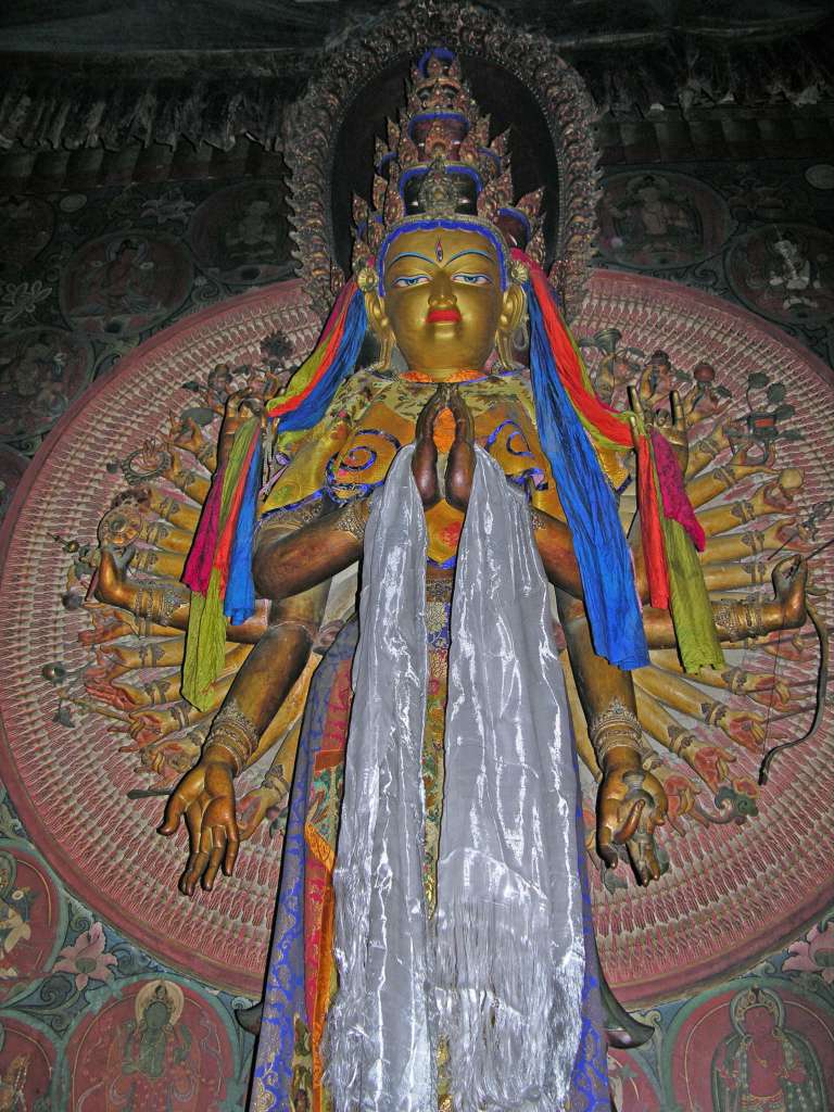 03-2 Avalokiteshvara 11 Heads 1000 Arms The second form of Avalokiteshvara has 1000 arms and 11 faces. In front of Amitabha, Avalokiteshvara vowed to work unceasingly to end the suffering of all sentient beings, vowing that if he should ever give up, �May my head be cracked into 10 pieces and my body split into 1000 pieces.� Avalokiteshvara then entered into a state of prolonged intense and uninterrupted meditation, but when he finally arose he realized he had succeeded in liberating only a small number of beings from suffering. His heart filled with sorrow, and in frustration, he cried out that he was ready to give up. In that instant of despair, his head cracked into 10 pieces and his body shattered into 1000 pieces. In agony Avalokiteshvara called out to Amitabha, who restored Avalokiteshvara�s broken body, transforming it into 1000 arms, each palm with an all-seeing eye. This increased by 1000 times the mighty Bodhisattva�s capacity to help all sentient beings. In the same way, Amitabha changed the broken head into 10 faces, nine of which were fashioned in a compassionate aspect and one in a wrathful aspect. At the top Amitabha placed his own face, indicating how happy he was with Avalokiteshvara�s bodhichitta motivation.